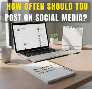 Laptop showing social media content calendar on desk with notebook and headline about posting frequency for small businesses